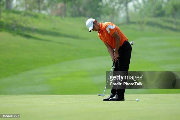 golfer putting - xlarge - golf putter stock pictures, royalty-free photos & images
