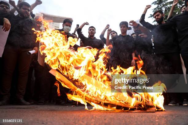 Protesters burn a representation of the Israeli flag in front of the Swedish Embassy after the Nordic nation allowed an Iraqi man to insult the holy...