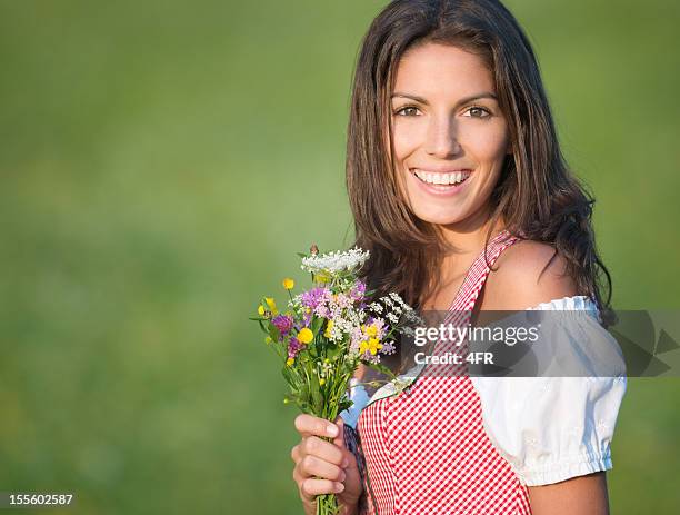 beautiful woman in dirndl fashion holding a flower bouquet (xxxl) - traditionally austrian 個照片及圖片檔