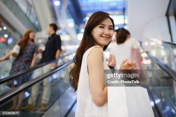 beautiful young women with shopping bag - xxxlarge - finance talk stockfoto's en -beelden