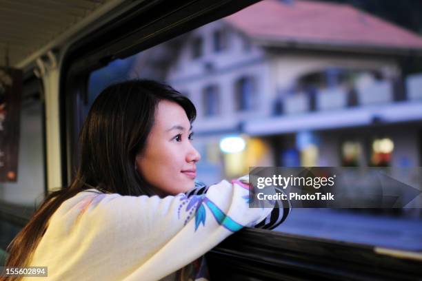 woman waiting and looking through window - xlarge - railroad car stock pictures, royalty-free photos & images