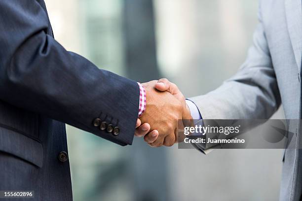 two businessmen shaking hands - gripping stock pictures, royalty-free photos & images