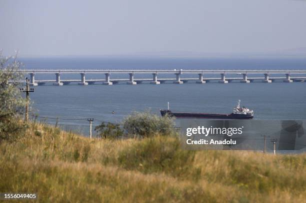 Cargo ship crosses the Kerch Strait as the Crimea bridge is seen behind as Russia-Ukraine war continues in Crimea on July 25, 2023. Car ferries...