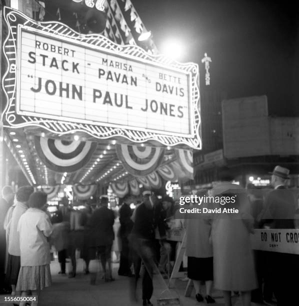 Crowds wait outside the Rivoli Theater at 1620 Broadway for the world premiere of the movie "John Paul Jones," starring Bette Davis, Robert Stack,...