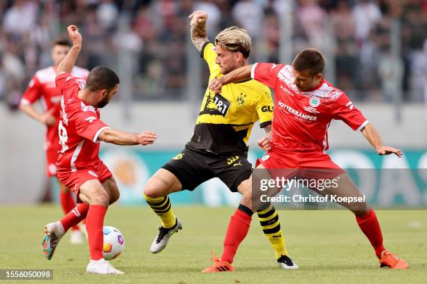 Matona-Glody Ngyombo of Oberhausen and Christian Maerz of Oberhausen challenge Ole Pohlmann of Dortmund during the pre-season friendly match between...