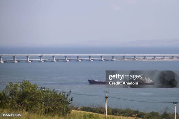 Cargo ship crosses the Kerch Strait as the Crimea bridge is seen behind as Russia-Ukraine war continues in Crimea on July 25, 2023. Car ferries...