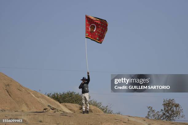 An Economic Freedom Fighters supporter waves a flag at the EFF Birthday Rally, celebrating the 10th anniversary of the party, in Marikana on July 26,...