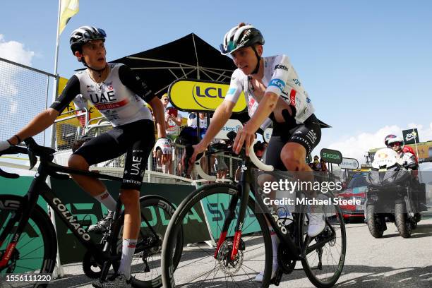 Marc Soler of Spain and Tadej Pogacar of Slovenia and UAE Team Emirates - White Best Young Rider Jersey cross the finish line during the stage...