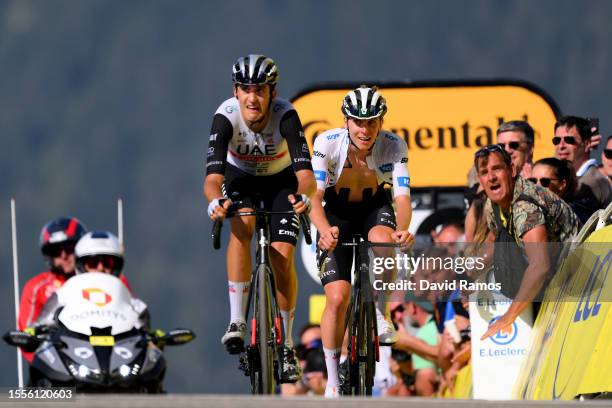 Marc Soler of Spain and Tadej Pogacar of Slovenia and UAE Team Emirates - White Best Young Rider Jersey cross the finish line during the stage...