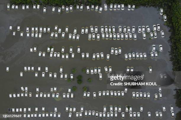 This aerial picture shows a parking area flooded in Suthiyana, Greater Noida on July 26 after the Hindon River, a tributary of the Yamuna River,...