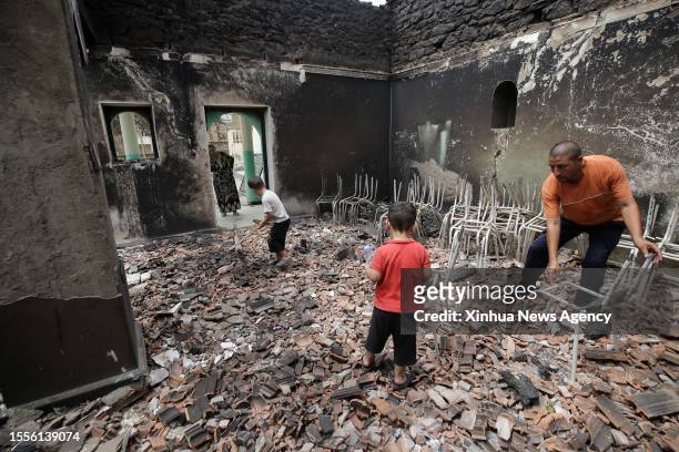 Man inspects a house burned in a wildfire in Bejaia Province, Algeria, on July 25, 2023. The death toll from wildfires in northern Algeria has risen...
