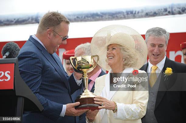 Camilla, Duchess of Cornwall presents the Melbourne Cup trophy to winning owner Nick Williams after Green Moon won the Emirates Melbourne Cup during...