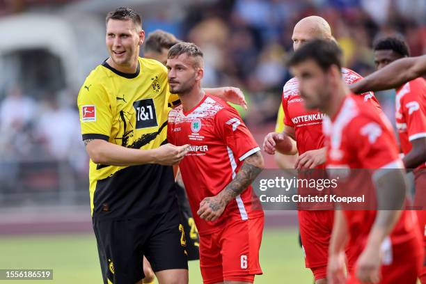 Niklas Suele of Dortmund and Fabian Holthaus of Oberhausen interact during the pre-season friendly match between Rot-Weiß Oberhausen and Borussia...