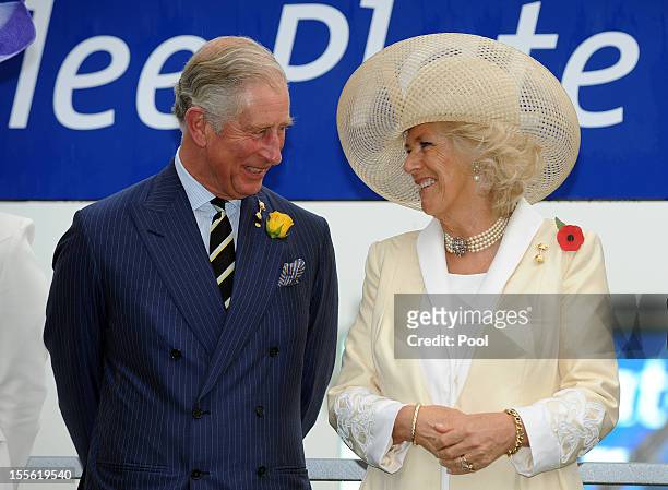Camilla, Duchess of Cornwall and Prince Charles, Prince of Wales share a joke after presenting the Diamond Jubilee Plate to the winning horse owner...