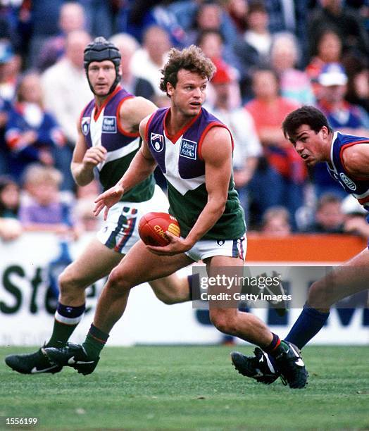 Scott Watters of Fremantle prepares to hand ball, in the match between Footscray and the Fremantle Dockers, during round five of the AFL season,...