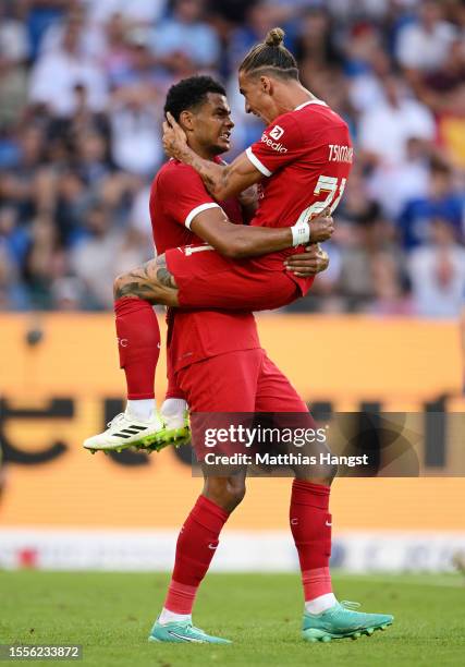 Cody Gakpo of Liverpool celebrates with teammate Kostas Tsimikas of Liverpool after scoring his team's second goal during the pre-season friendly...