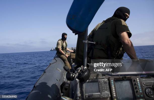 Israeli naval special forces ride a boat after the Israeli navy intercepted a Gaza-bound aid flotilla in the Mediterranean Sea on May 31, 2010 in a...