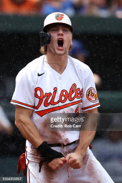 Gunnar Henderson of the Baltimore Orioles celebrates after scoring a run in the first inning against the Los Angeles Dodgers at Oriole Park at Camden...