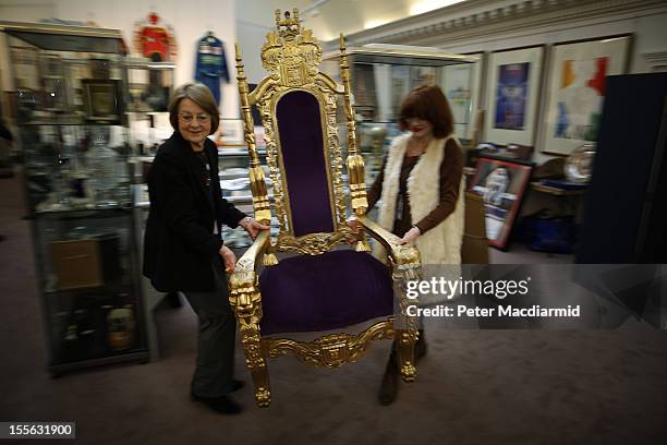 Auction staff move the Bradley Wiggins London 2012 Olympics golden throne into place at Sotheby's on November 6, 2012 in London, England. Graham Budd...