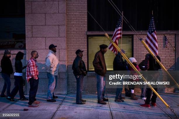 Voters wait in front of the Mt. Pleasant Library November 6, 2012 in Cleveland, Ohio. Citizens around the United States head to the polls to vote on...