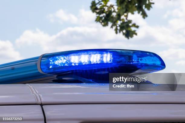 police light on a car of the german police - police lights stock-fotos und bilder