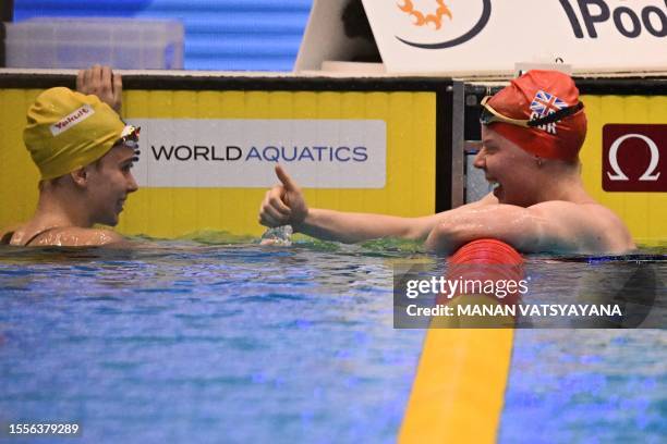 Australia's Elizabeth Dekkers speaks with Britain's Laura Stephens after competing in a semi-final heat of the women's 200m butterfly swimming event...