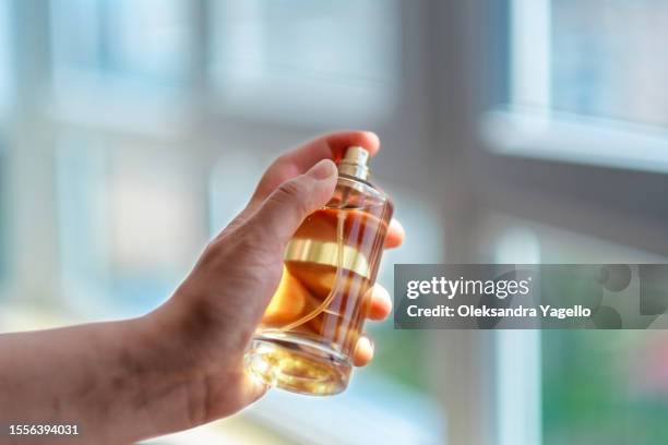 unrecognizable bottle of perfume in hand - perfume sprayer bildbanksfoton och bilder