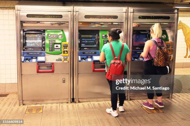 People get metro cards at the Lexington Avenue/59th Street subway station on July 19, 2023 in New York City. The MTA board announced that subway and...