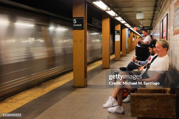 People wait for the train at the Lexington Avenue/59th Street subway station on July 19, 2023 in New York City. The MTA board announced that subway...