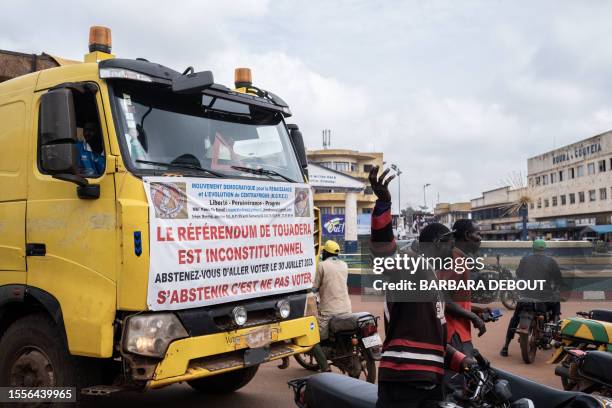 Rare poster calling for the boycott of the upcoming referendum is seen hung on the vehicle of opposition politician Joseph Bendouga, in Bangui, July...