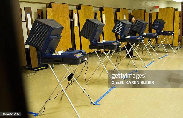 Voter casts her ballot at one of five machines at the Stonewall Middle School November 6, 2012 in Manassas, Prince William County, Virginia. After a...