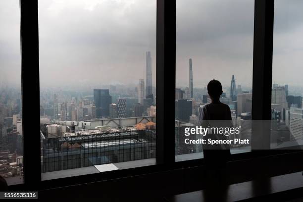 Child looks out at a hazy Manhattan skyline from an overlook in midtown Manhattan on July 19, 2023 in New York City. An air quality alert remained in...