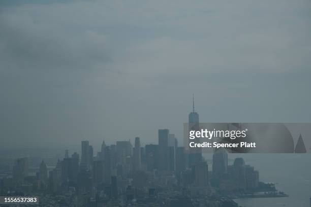 Hazy Manhattan skyline greets visitors to an overlook in midtown Manhattan on July 19, 2023 in New York City. An air quality alert remained in effect...