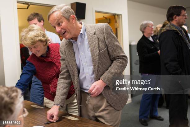 Senate candidate, Rep. Todd Akin , his wife, Lulli Akin, and son, Wynn Akin, speak to poll workers before casting their ballots November 6, 2012 in...