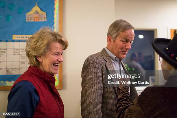 Senate candidate, Rep. Todd Akin and his wife, Lulli Akin speak to a voter as they wait in line to vote November 6, 2012 in Wildwood, Missouri. Akin,...