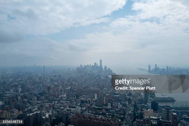 Hazy Manhattan skyline greets visitors to an overlook in midtown Manhattan on July 19, 2023 in New York City. An air quality alert remained in effect...
