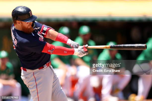 Justin Turner of the Boston Red Sox hits into a fielders choice that scored a run against the Oakland Athletics in the fifth inning at RingCentral...