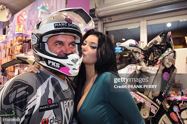 Fifth-time Paris-Dakar moto competitor, French amator Hugo Payen , poses in a Dorcelstore on November 19, 2011 in Saint-Herblain near the western...