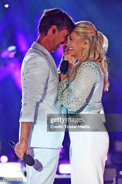 In this photo released on July 26 Florian Silbereisen and Beatrice Egli perform during the Schlager tv show "Die grosse Schlagerstrandparty - Wir...