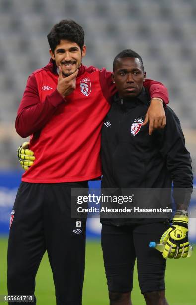 Tulio De Melo smiles with his team mate Barel Mouko during a OSC Lille training session ahead of their UEFA Champions League group F match against FC...