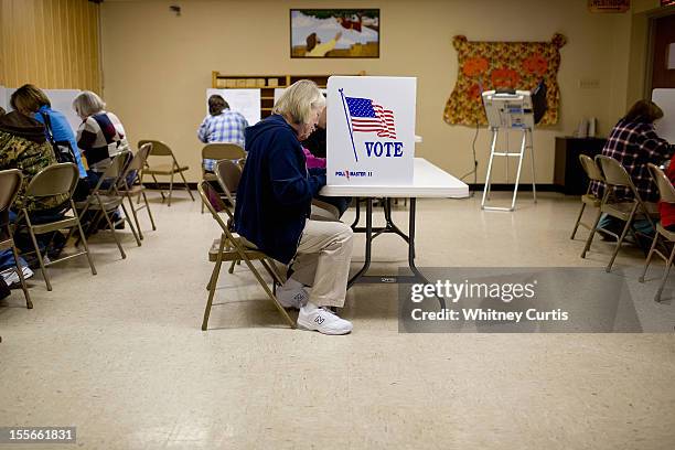 Angie Austin casts her ballot with other voters in the presidential election November 6, 2012 at United Methodist Church in Gray Summit, Missouri. As...