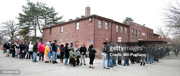 Citizens wait in a long line to vote in the presidential election at Community House November 6, 2012 in Detroit, Michigan. The race between...