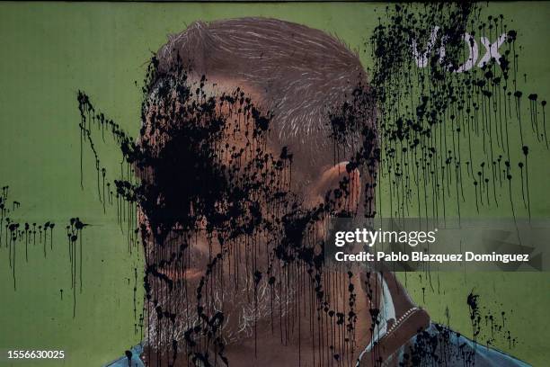 An advertisement billboard of far-right wing party VOX with an image depicting its leader Santiago Abascal is seen vandalised with black paint during...