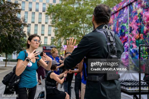 An American Sign Language interpreter communicates with a concertgoer wearing a haptic suit created for the deaf community by Music: Not Impossible,...