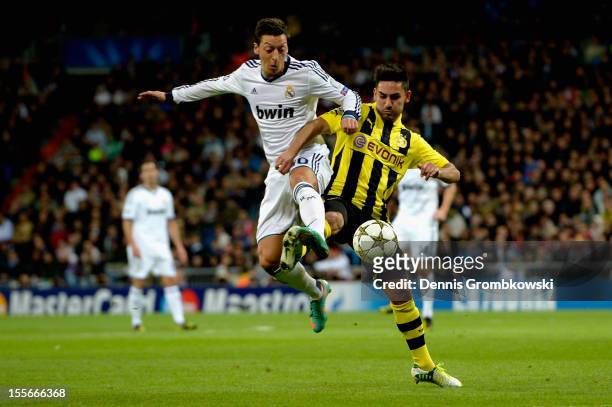 Mesut Oezil of Madrid and Ilkay Guendogan of Dortmund battle for the ball during the UEFA Champions League Group D match between Real Madrid and...