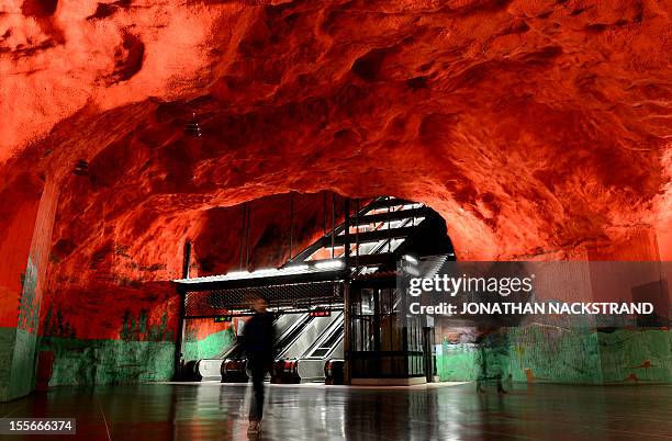 People walk at the Solna metro station on November 6, 2012 in Stockholm, Sweden, decorated in the 1970's by artists Anders Aberg and Karl-Olov Bjor....