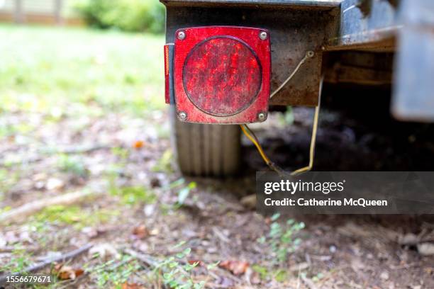 low angle view of hitch transport trailer with back red brake tail light visible - remolcar fotografías e imágenes de stock
