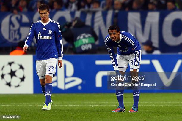 Roman Neustaedter and Joel Matip of Schalke look dejected after the first goal of Arsenal during the UEFA Champions League group B match between FC...