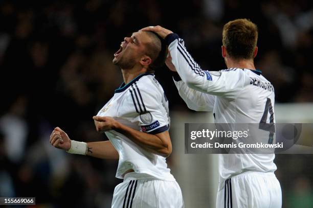 Pepe of Madrid celebrates with teammate Sergio Ramos after scoring his team's first goal during the UEFA Champions League Group D match between Real...