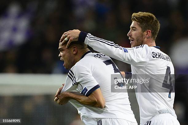 Real Madrid's Portuguese defender Pepe celebrates with his teammate defender Sergio Ramos after scoring during the UEFA Champions League football...